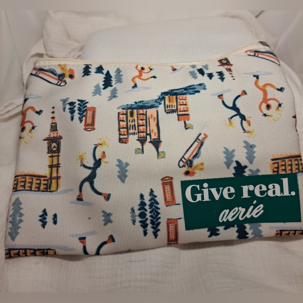 Aerie cosmetic bag in white with travel drawings and zipper.